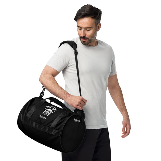 "Bolsa cilíndrica de 30 litros, color negro, con imagen estampada de una calavera con gorro de piloto de cuero y gafas, sobre la frase Rider&Road Motorcycle - 30-liter cylindrical bag, black, with a printed image of a skull wearing a leather pilot's cap and goggles, above the phrase Rider&Road Motorcycle"